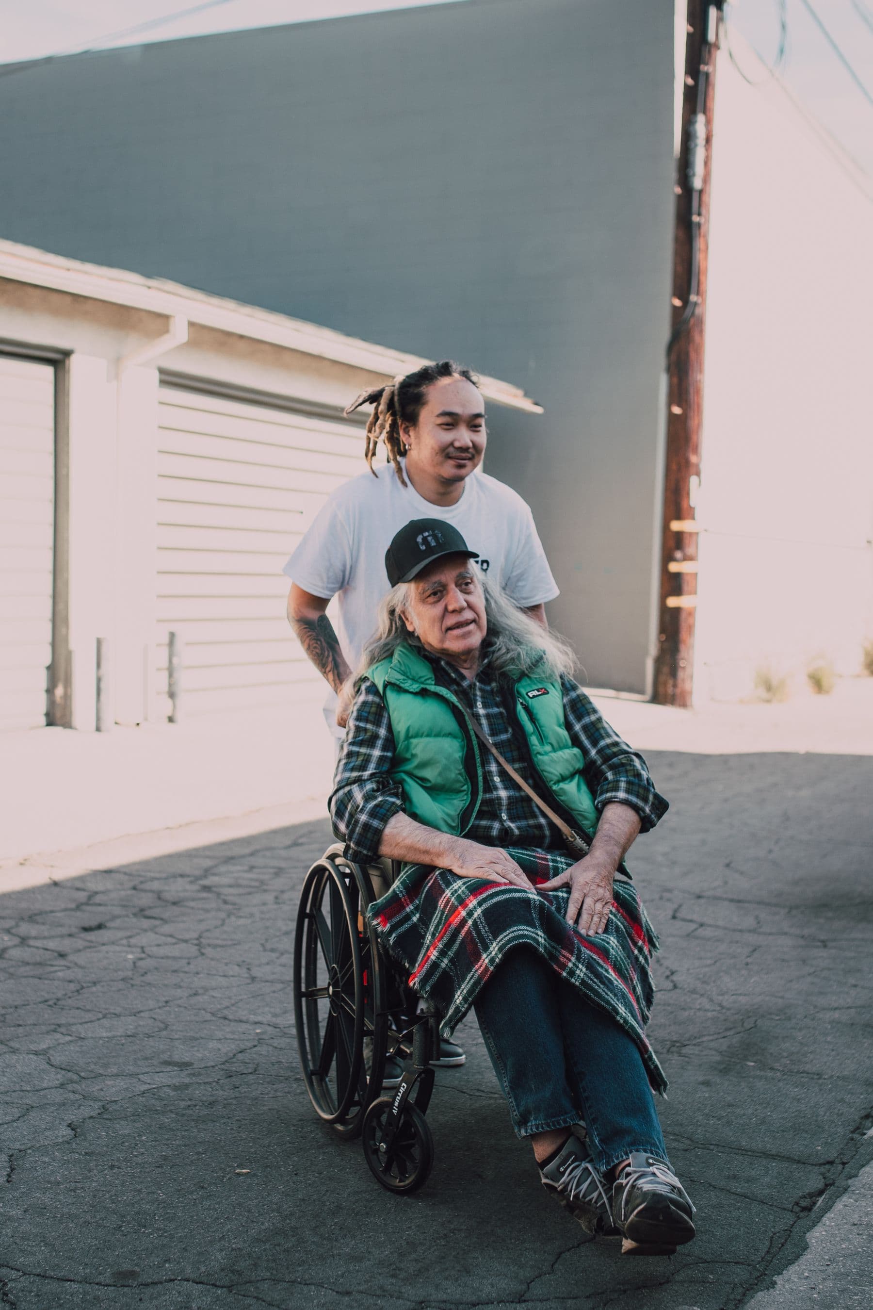 Young volunteer helping an elderly neighbour with dignity — documentary community care